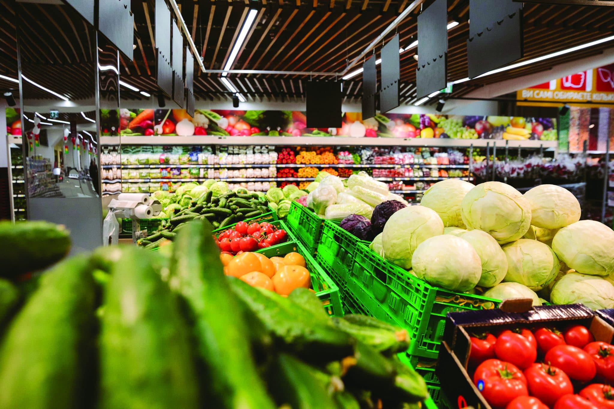 Inside a dark store: crates of fresh vegetables and fruit